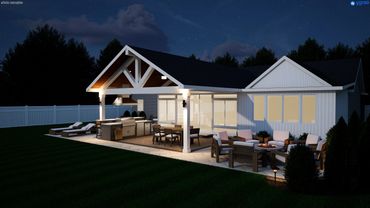 Night view of a modern backyard with a covered patio, outdoor kitchen, and seating area around a fire pit.