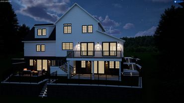 Modern two-story house illuminated at night with outdoor seating and stairs.