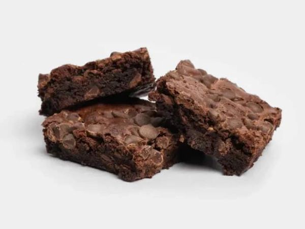 Three rich, chocolate brownies with a moist, dense texture, studded with chocolate chips.