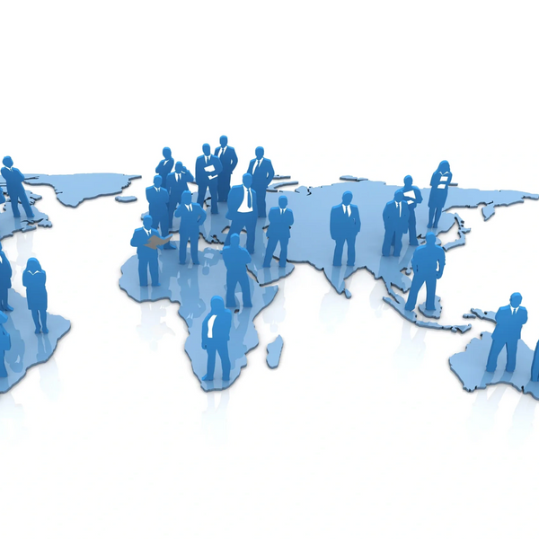 Blue silhouettes of business people standing on a world map.