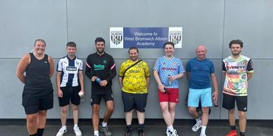 Proud Baggies' footballers standing outside of the WBA Community Sports Hall.