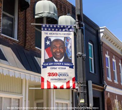 Banner honoring Rear Adm. Stephen D. Barnett as a combat veteran.