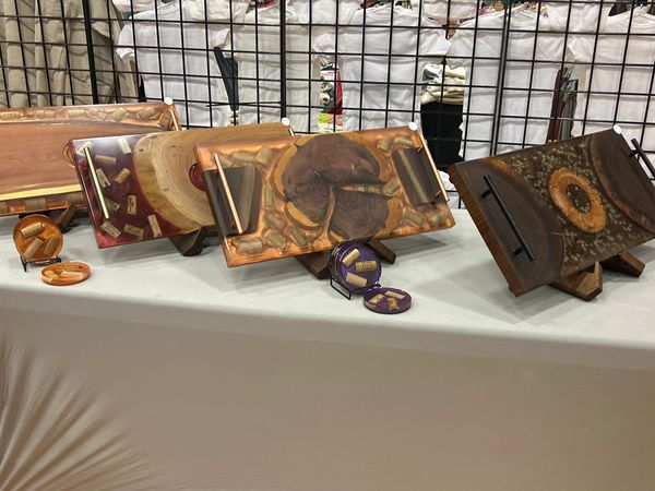 Wooden serving trays and coasters with embedded wine corks on display.