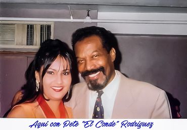 Elisabeth Timbal stands proudly with legendary salsa singer Pete “El Conde” Rodríguez after her elec