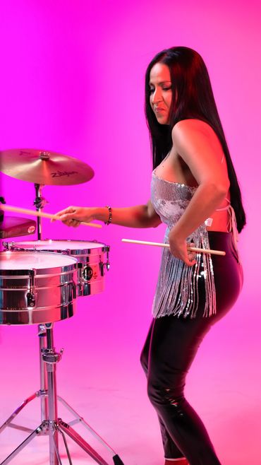 Elisabeth Timbal commands the stage as she performs on her timbales during the recording of “Por Las