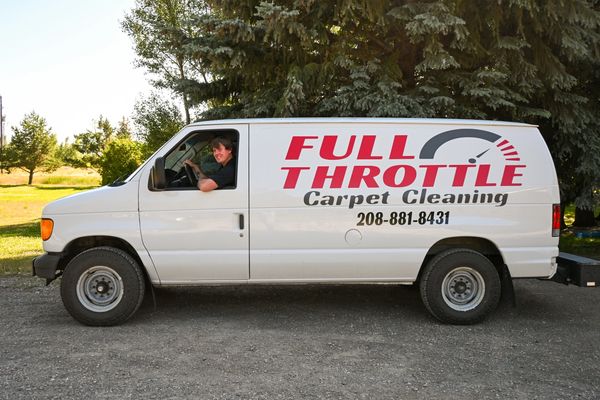 Man smiling in a Full Throttle Carpet Cleaning van.