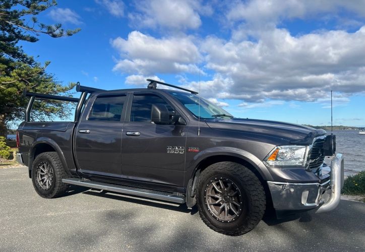 Ram 1500 truck parked next to Nelson Bay under a blue sky.