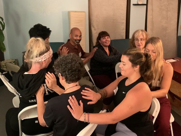 Reiki practitioners sitting in a Reiki circle. A Reiki Mawashi exercise.