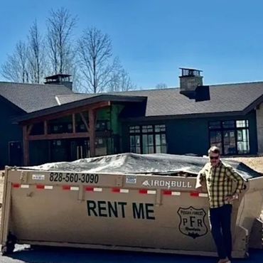 Dumpster rental in Hendersonville NC with the owner of Pisgah Forest Dumpsters standing beside unit