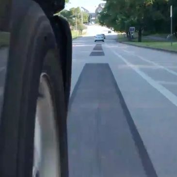 a singing road pathway affixed to the road surface like a mathematically refined rumble strip