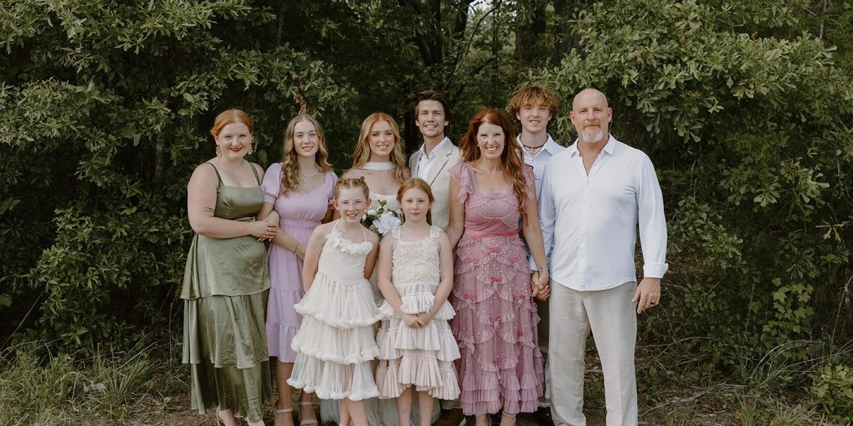 Family portrait outdoors with everyone dressed nicely