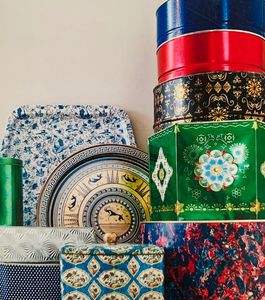 A collection of colorful vintage tins that have been thrifted to be repurposed into one of a kind je