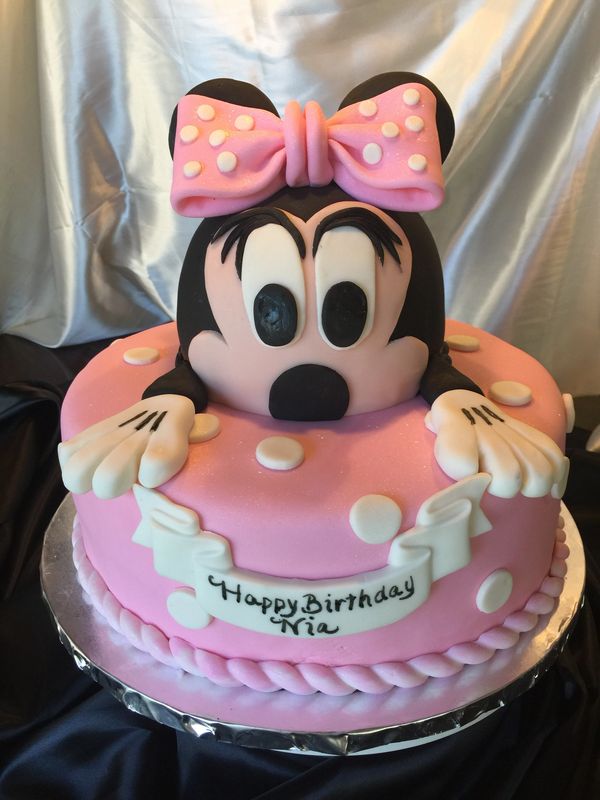 pink cake with Minnie Mouse on top