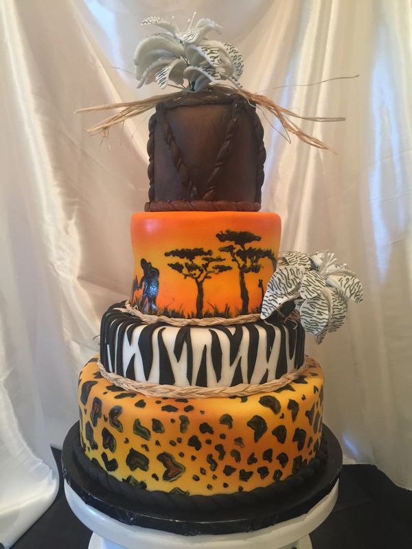 4 tier African themed cake, leopard, zebra, safari and drum layers with black and white flowers