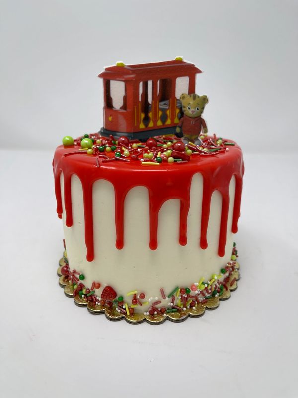 white cake red drip with cable car and b