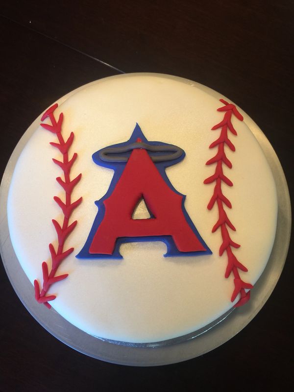 white round cake with baseball stitching and Angels logo