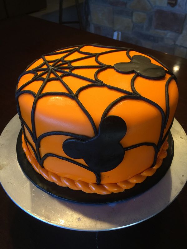 orange cake with black spider web and black mouse outline