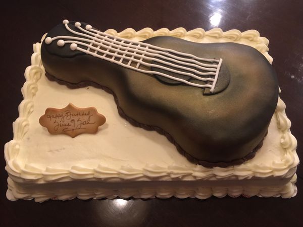 white cake with brown guitar on the top