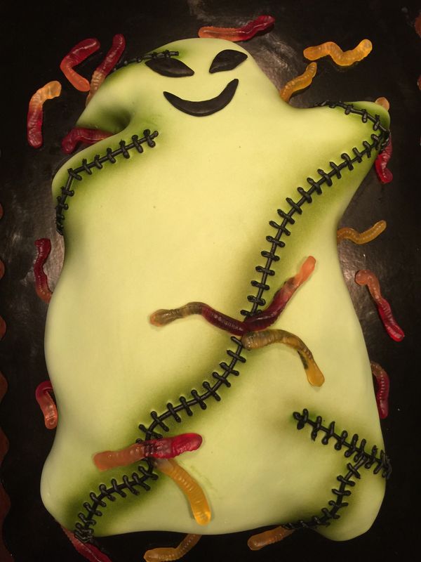 green monster cake with stitching and gummy worms 