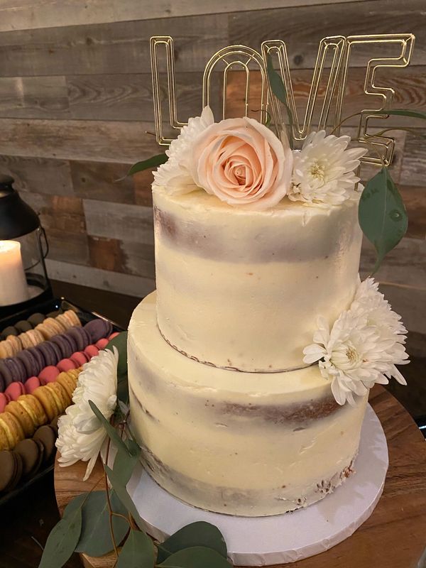 white naked cake with fresh flowers