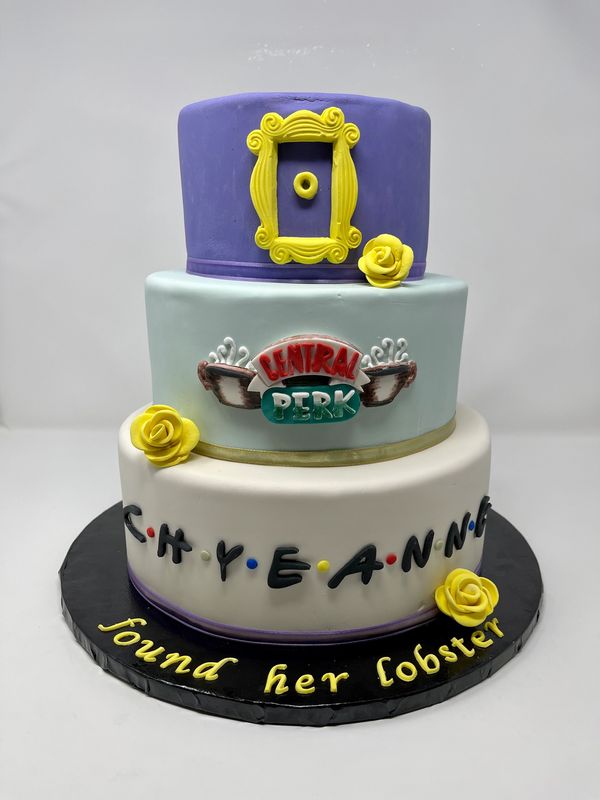 3 tier friends cake with Central Perk logo and yellow roses