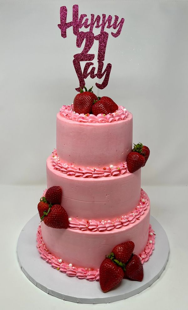 3 tier pink cake with strawberries