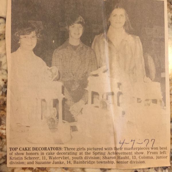 newspaper clipping of 3 people and their prize winning cakes