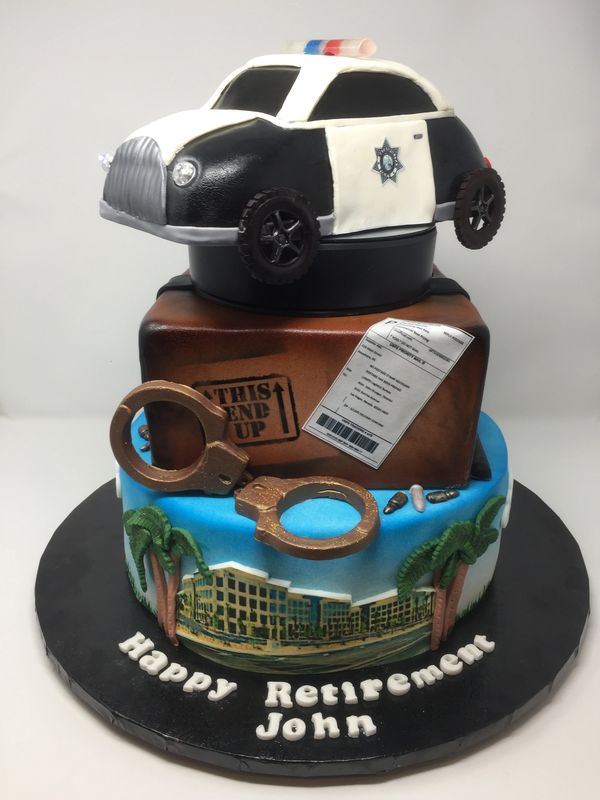 3 tier cake with police headquarters, a box and a police car.
