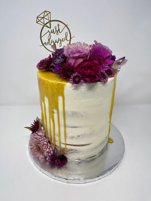 white cake with purple flowers.