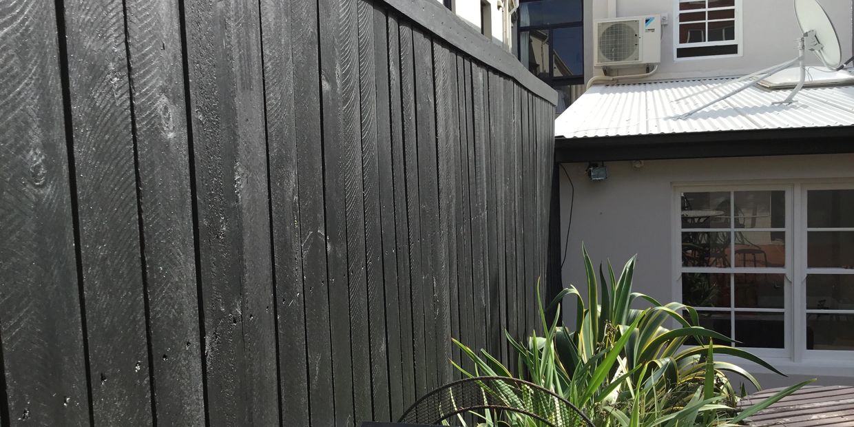 Spray painting timber fence