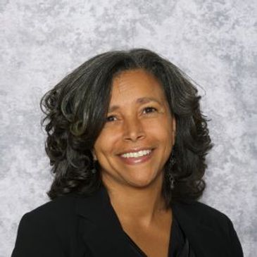 Headshot of Dr. Paula Smith with grey background 