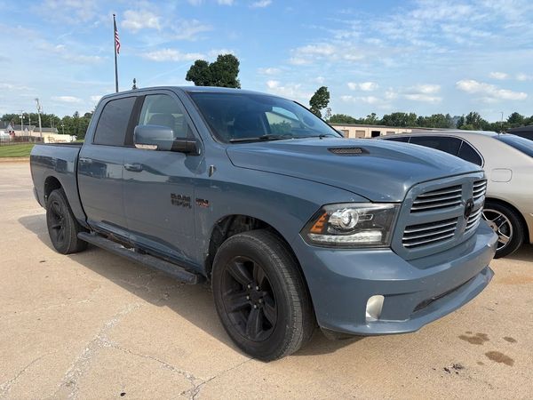 Blue Dodge Ram pickup truck parked outdoors under a clear sky.