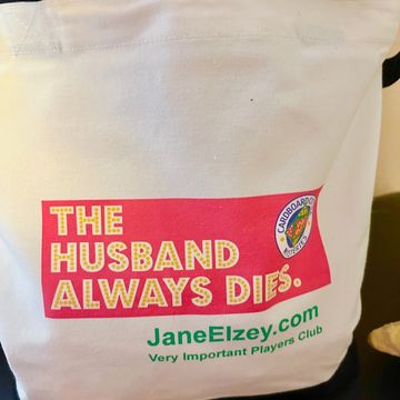 white canvas shopping bag with the husband always dies logo in pink