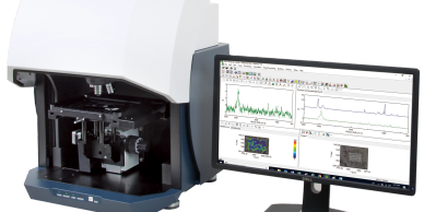 Scientific instrument with computer monitor displaying data and graphs.