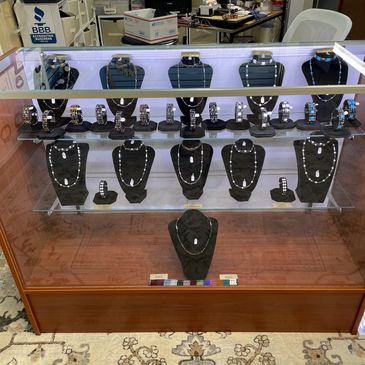 Display case filled with magnetic rings and therapeutic accessories.