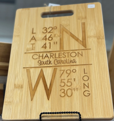 Wooden cutting board with Charleston, South Carolina coordinates engraved.