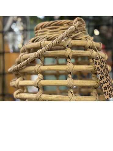 Close-up of a woven wicker basket with a leopard print tag.