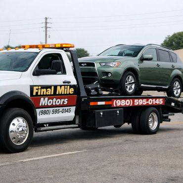 Tow truck from Final Mile Motors carrying a green SUV.
