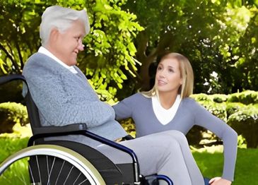 Woman assisting senior man in wheelchair outdoors.