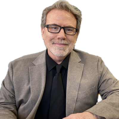 Smiling man in gray suit and black tie with glasses.