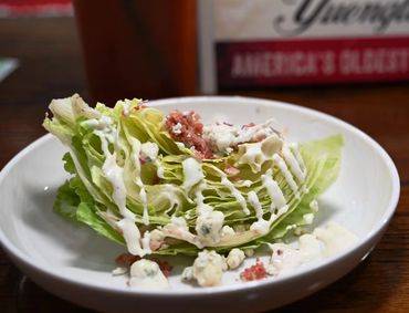 Wedge Salad: Iceberg Lettuce with Blue Cheese Crumbles, Bacon, Tomatoes and Buttermilk Ranch