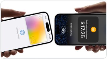 Two smartphones using contactless payment technology in close proximity.