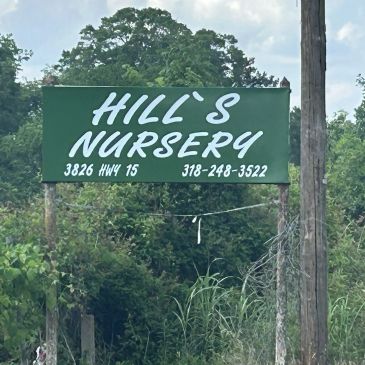 Sign for Hill's Nursery with contact information.