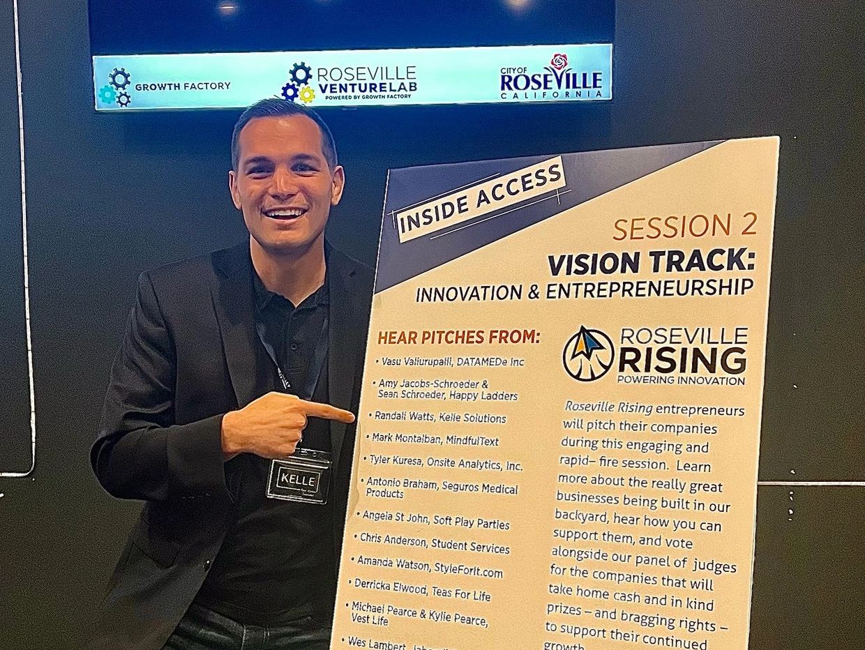 Randall posing with a poster of Roseville Rising