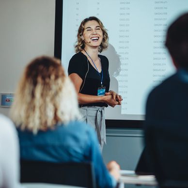 Woman presenting in a professional environment.