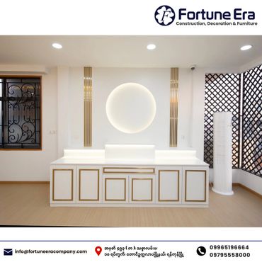 Modern white and gold cabinet with circular backlight in a stylish room.