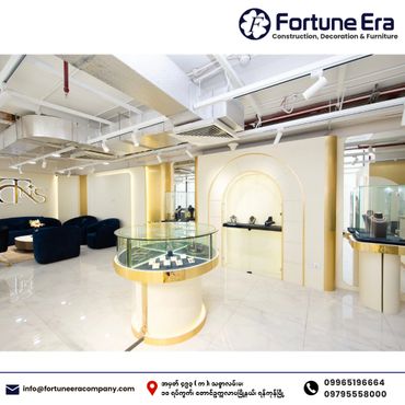 Luxurious jewelry showroom with gold accents and modern design.
