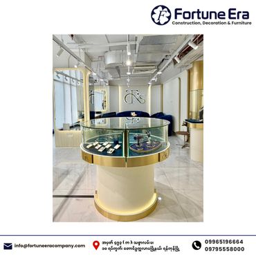 Elegant jewelry display in a modern showroom with gold accents and glass cases.