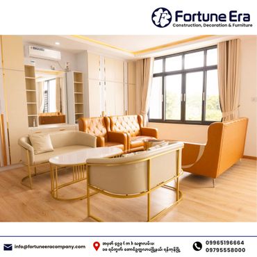 Modern living room with stylish beige and brown sofas and a large window.