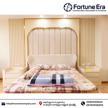 Modern bedroom with beige upholstered headboard and matching nightstands.